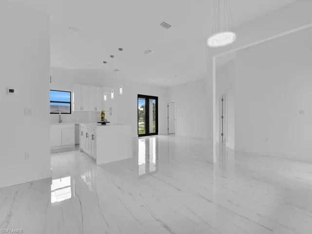 Tiled spare room with french doors
