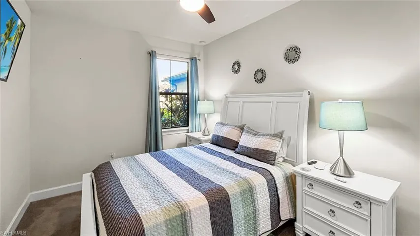 Carpeted bedroom with ceiling fan