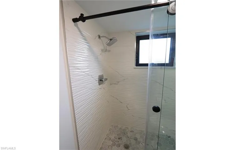 Full bath featuring a shower stall