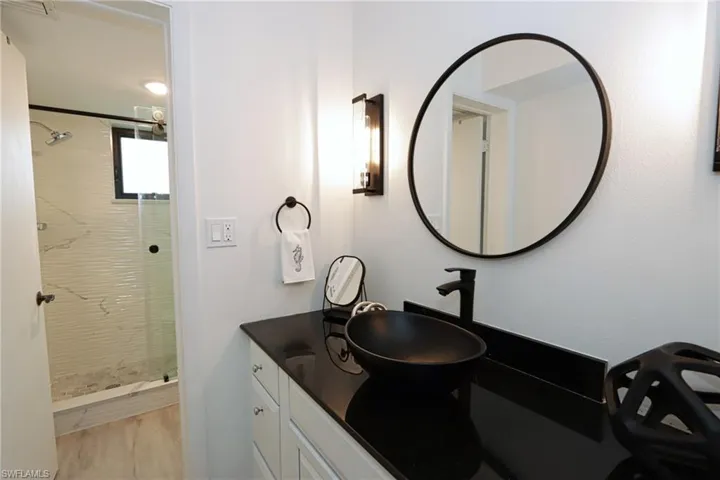 Bathroom featuring a stall shower and vanity