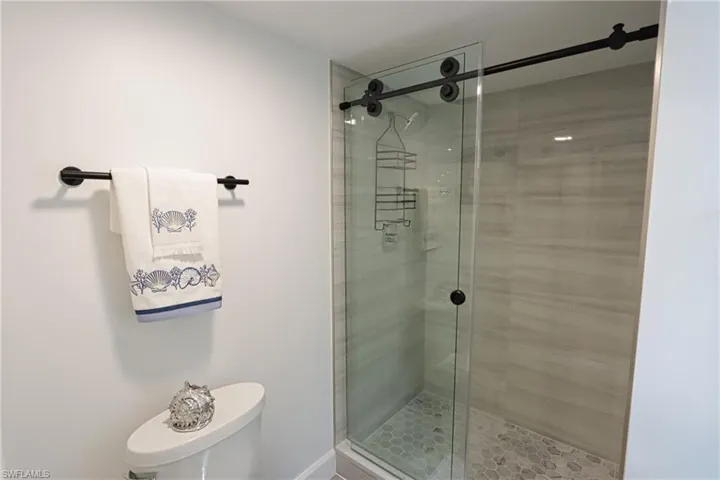 Bathroom featuring toilet and a shower stall