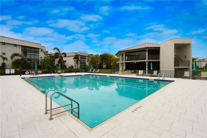 Community pool featuring a patio and a residential view
