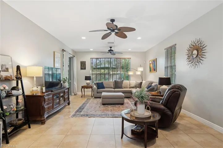Tiled living room featuring ceiling fan