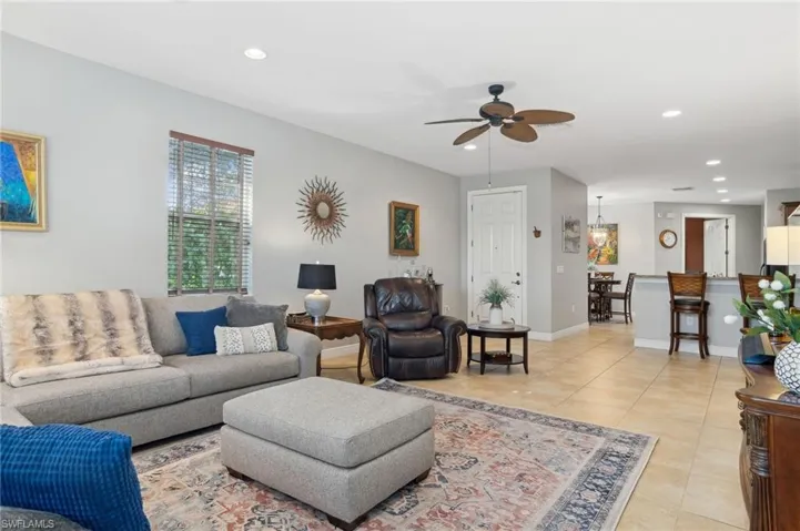 Living room featuring ceiling fan and light tile patterned floors