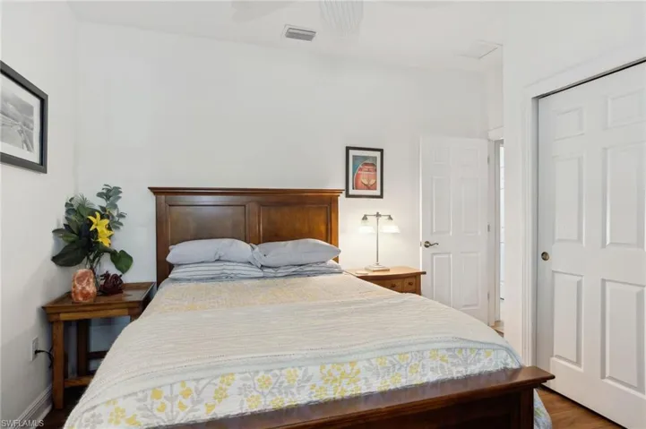 Bedroom featuring hardwood / wood-style floors, a closet, and ceiling fan