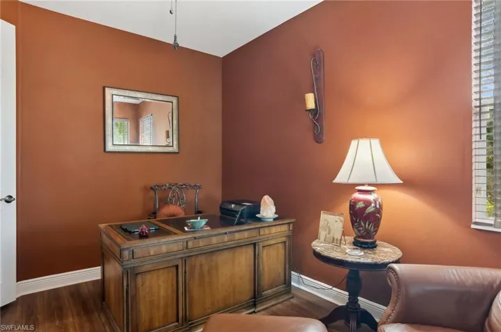 Office space featuring dark wood-type flooring