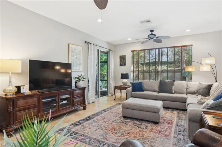 Tiled living room featuring ceiling fan