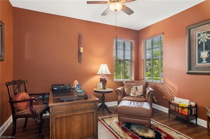 Office space with ceiling fan and dark hardwood / wood-style floors