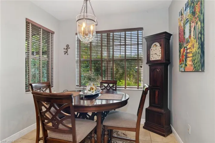 Tiled dining area with an inviting chandelier