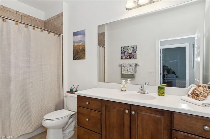 Bathroom with vanity, toilet, and walk in shower