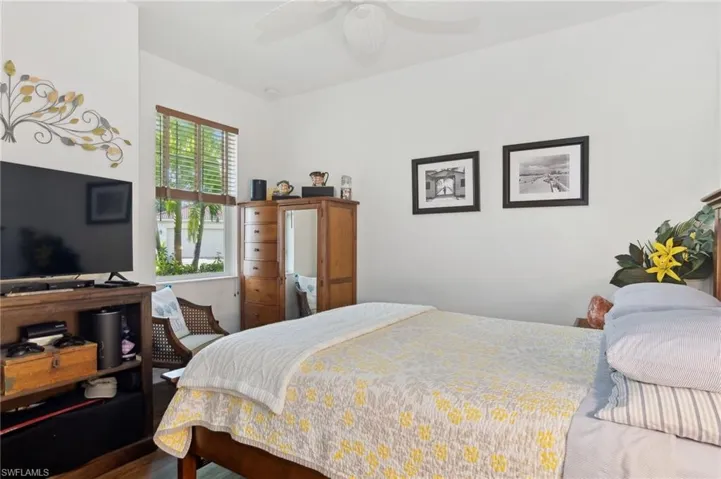 Bedroom with hardwood / wood-style floors and ceiling fan