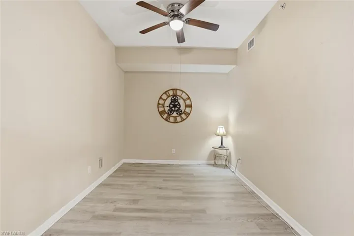 Empty room featuring light wood-style flooring and ceiling fan