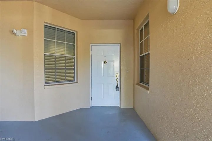 View of exterior entry with stucco siding