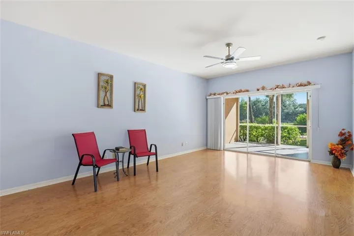 Sitting room with light wood finished floors and ceiling fan