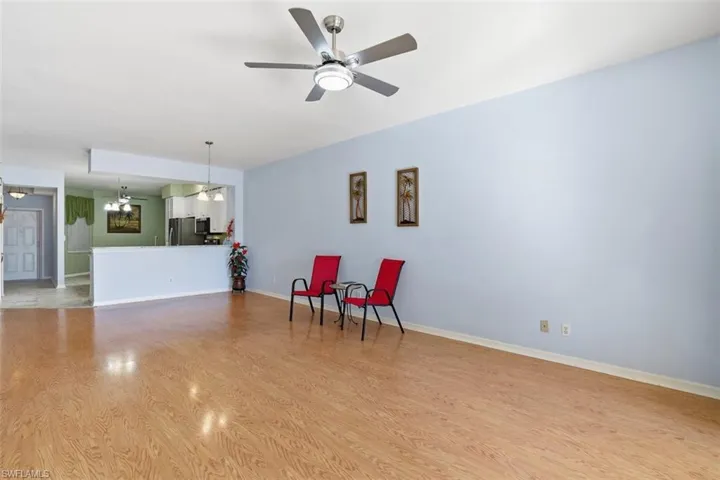 Sitting room with a ceiling fan and light wood-style flooring