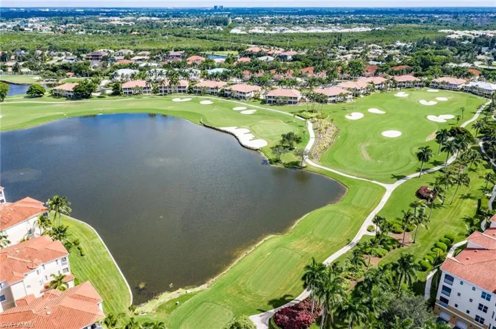 Aerial view featuring view of golf course, a water view, and a residential view