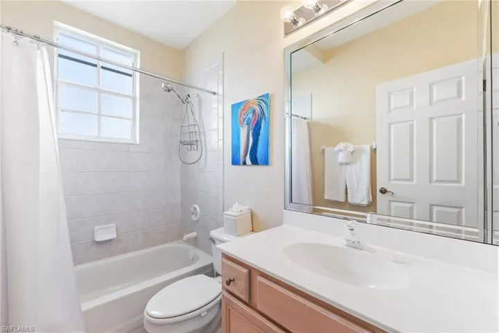 Full bathroom featuring toilet, shower / tub combo, and vanity