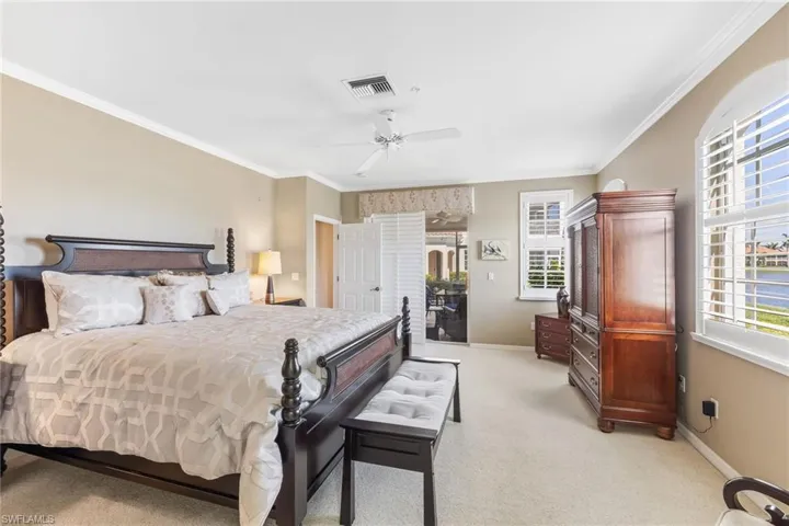 Bedroom with access to outside, multiple windows, visible vents, and baseboards