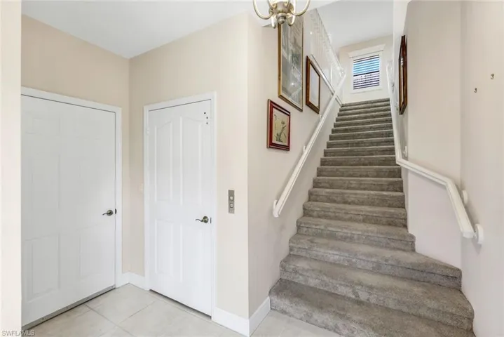 Entrance including interior garage access and elevator door