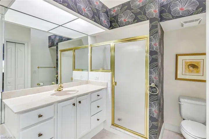 Primary bathroom with dual bowl vanity, walk in shower and soaking tub