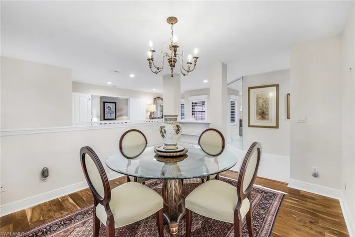 Dining room featuring a chandelier, a healthy amount of sunlight and wood flooring