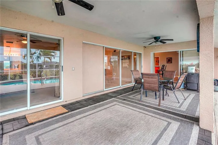 View of patio with outdoor dining space and a ceiling fan