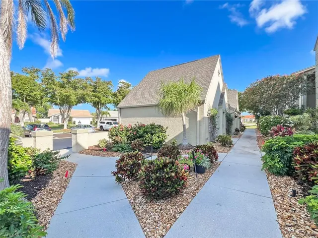 Landscaped walkway between garages and condos