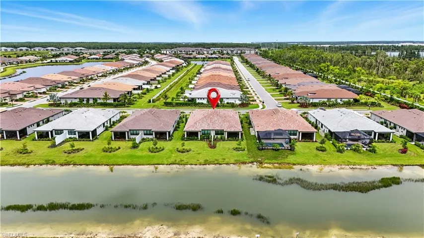 Aerial perspective of suburban area with a large body of water