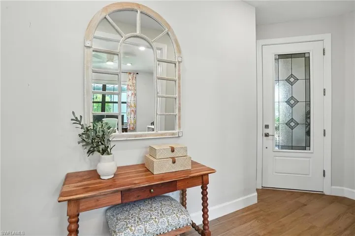 Foyer featuring wood finished floors and baseboards