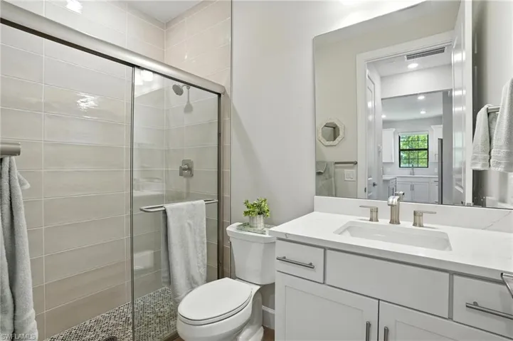 Full bathroom featuring vanity and a shower stall