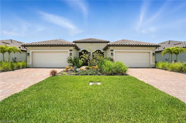 Mediterranean / spanish house featuring decorative driveway, an attached garage, and a front yard