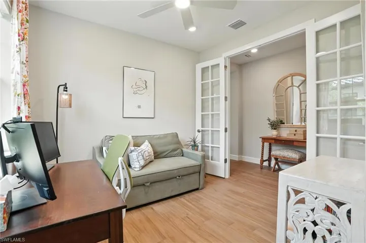 Home office featuring a ceiling fan, light wood-style floors, french doors, and recessed lighting