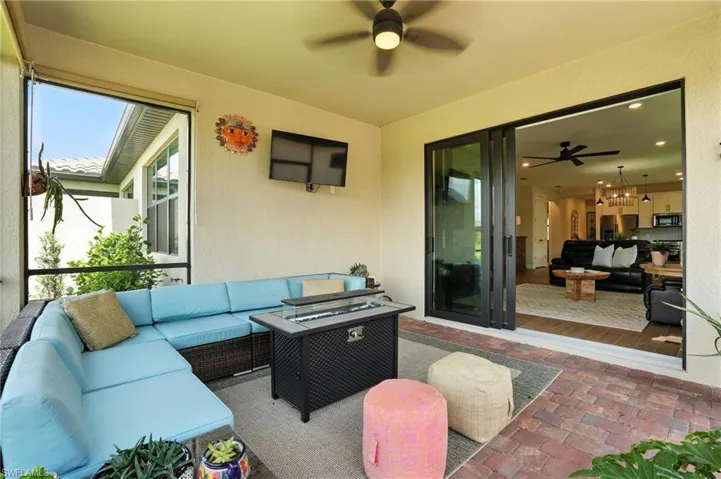 View of patio with an outdoor hangout area and a ceiling fan