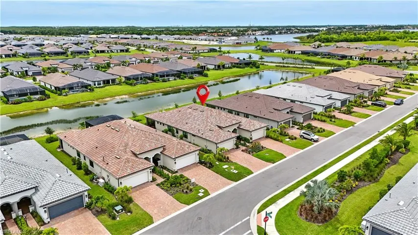 Aerial perspective of suburban area with a nearby body of water