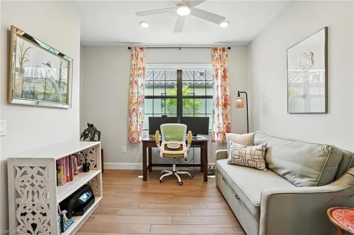 Office space featuring light wood-style flooring, a ceiling fan, and recessed lighting