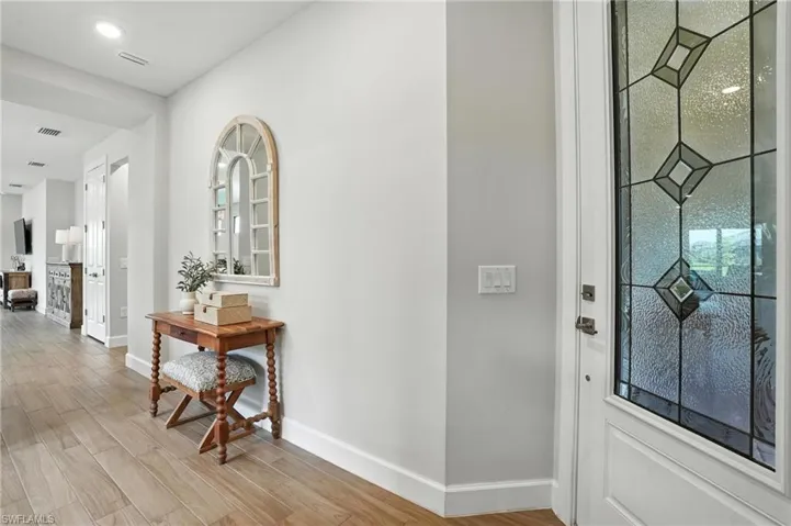 Entryway featuring baseboards and light wood-type flooring