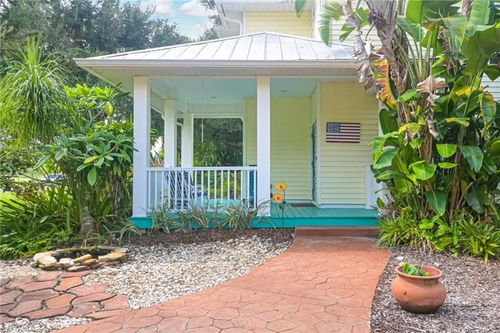 Pretty walkway to front porch with fish pond on the left.