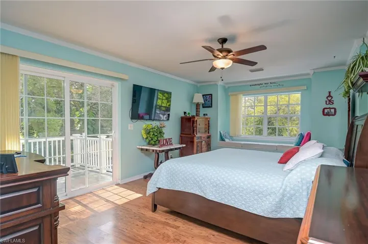 Spacious master bedroom with private balcony overlooking your tropical paradise.  Window seat overlooking the back yard. Crown molding, wood flooring and lots of natural light.