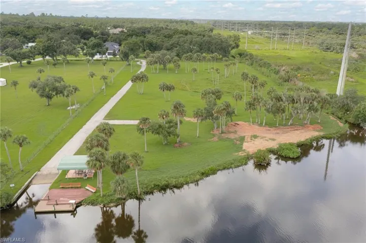 Aerial view of the 3 acre private community park with boat paved road leading to boat ramp, dock, covered picnic area and fishing area.