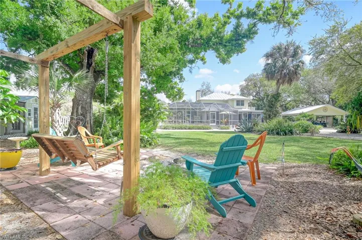 Outdoor firepit area with wooden swing for relaxing in the beautiful outdoors.