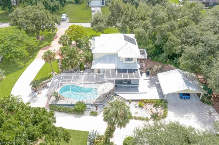 Taken from rear of home facing the street.  Lots of privacy and long circular driveway wraps around the back of the property through a solar gate.