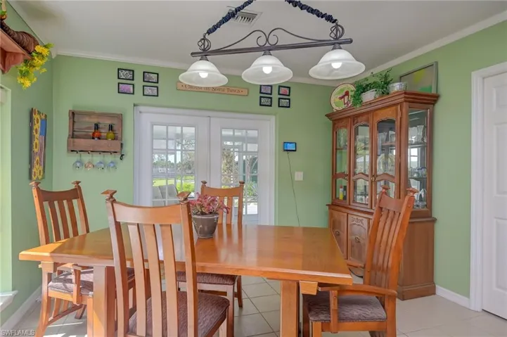 Cozy dining area overlooking the lush yard and lanai.
