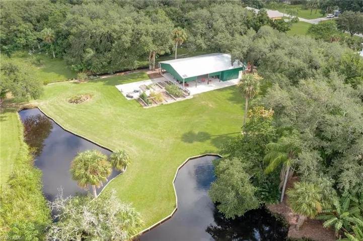 View of the winding pond with solar aerator and stocked with bluegill, tilapia and bass for lazy days of fishing with family and friends.