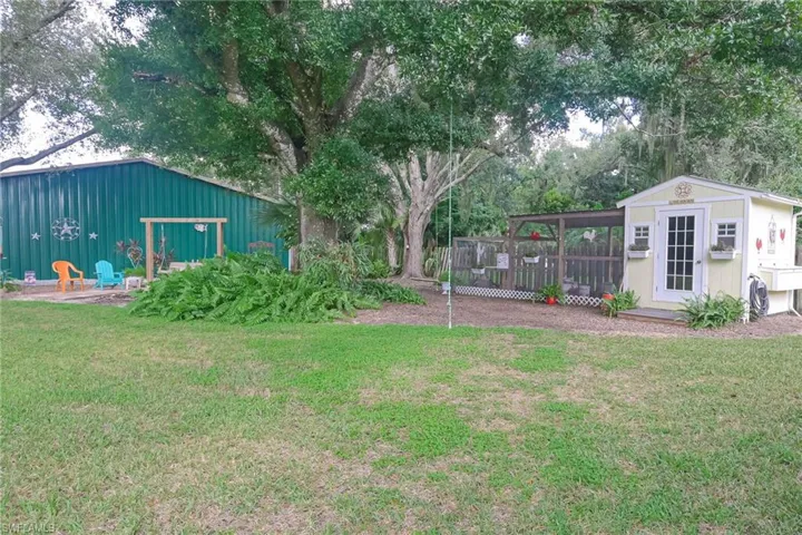 View of the chicken coop, firepit area and barn.