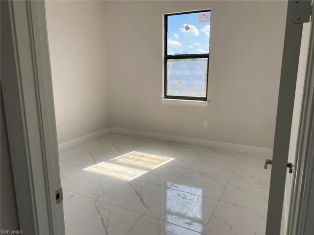 Empty room with light marble finish floors and baseboards