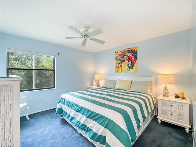 Bedroom featuring dark carpet and ceiling fan