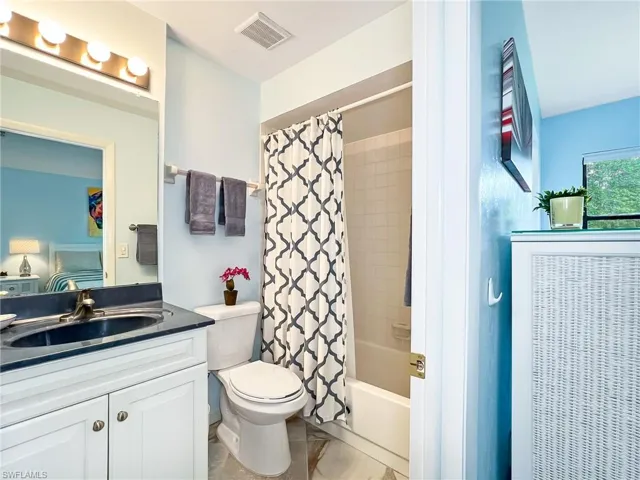 Full bathroom with vanity, toilet, and shower / bath combo