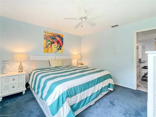 Carpeted bedroom with ceiling fan