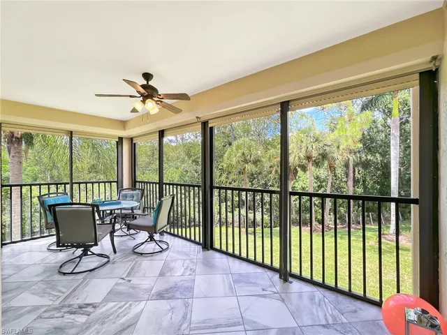 Sunroom / solarium featuring ceiling fan