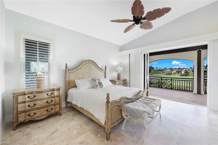 Bedroom featuring ceiling fan, vaulted ceiling, light tile patterned floors, and access to exterior